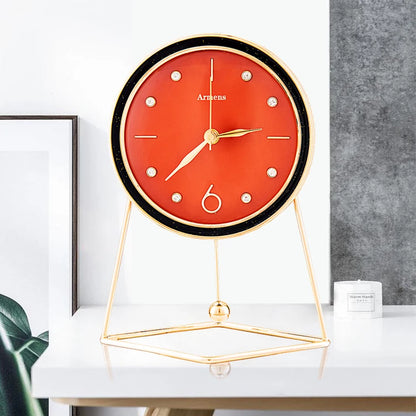 Pendulum Table Clock - Dralen: A modern tabletop clock with a deep-red face and gold accents on a minimalist gold stand, showcasing artistic motion with an open-concept design and rhythmic pendulum.