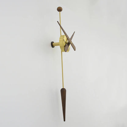Mid century modern wall clock - Ellroy features an exposed brass movement, wooden hands, and a walnut pendulum, creating a minimalist, sculptural design by The Horologista, mounted elegantly on a white wall.