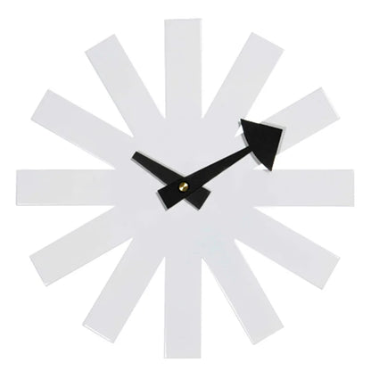 Black decorative clock in modern bedroom with neutral gray walls and wood furniture