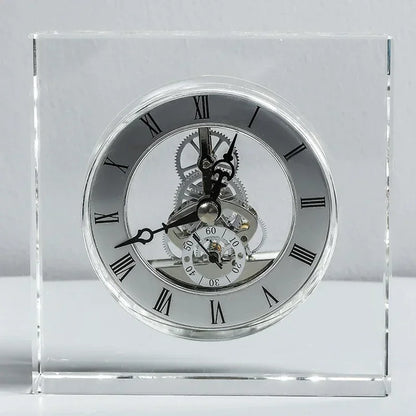 Crystal tabletop clock - Dunley: A striking freestanding desk clock encased in clear glass, showcasing Roman numerals, ornate hands, and visible metal gears, blending modern elegance with intricate craftsmanship.