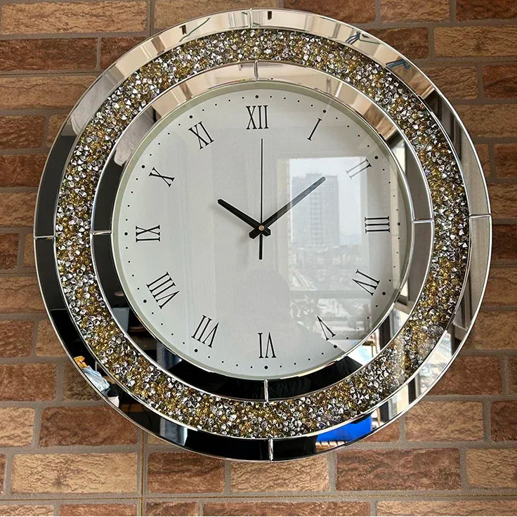 Fancy wall clock - Norwyn, featuring a white face with black Roman numerals, mirror-trimmed ring with crystal-like facets, mounted on a brick-patterned wall, embodying elegance and premium design.