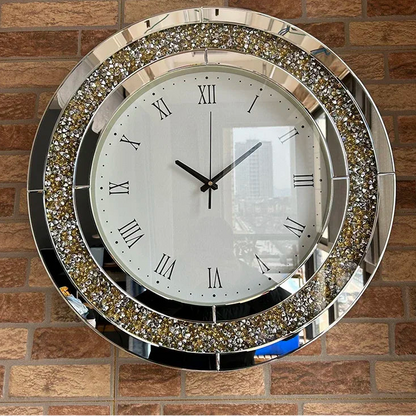 Fancy wall clock - Norwyn, featuring a white face with black Roman numerals, mirror-trimmed ring with crystal-like facets, mounted on a brick-patterned wall, embodying elegance and premium design.