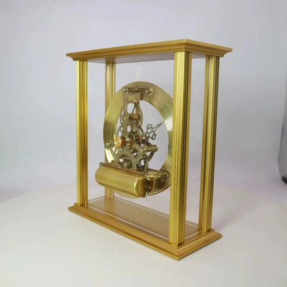 Brass table clock - Braven in a clear gold-colored case showcasing an intricate skeleton-style mechanism with visible brass gears and a coiled mainspring, offering timeless sophistication for any desk or mantel.