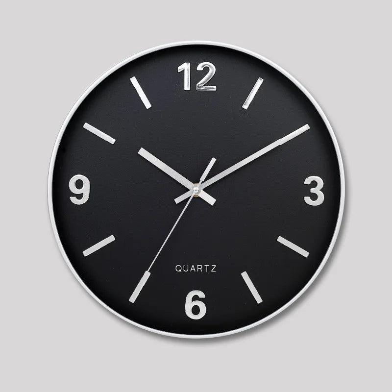 Modern Silent Wall Clock - Densford: A sleek, minimalist wall clock with a black face, slim white/silver bezel, and silent quartz movement, featuring numerals at 12, 3, 6, and 9.