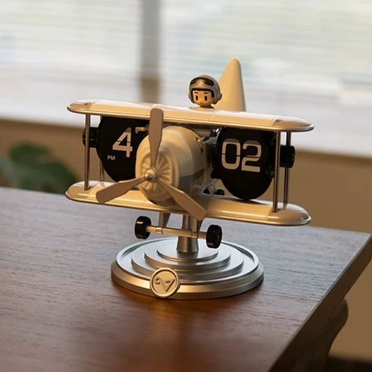 Vintage plane flip clock with biplane design on desk