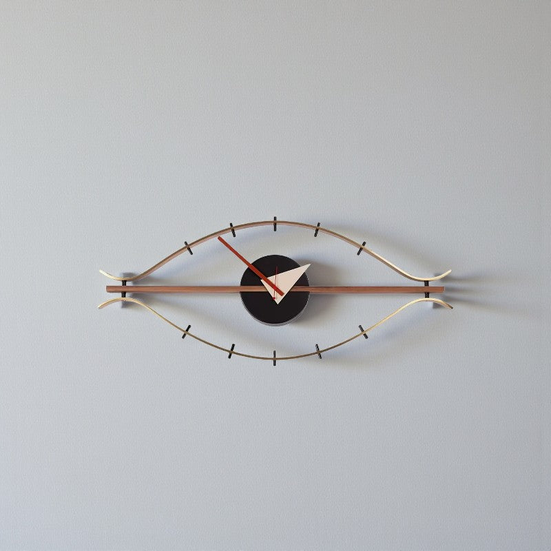 30-inch decorative wall clock - Ashen features an eye-shaped metal frame with a black clock face. Red and white hands add contrast, perfect for a vintage industrial touch from The Horologista.