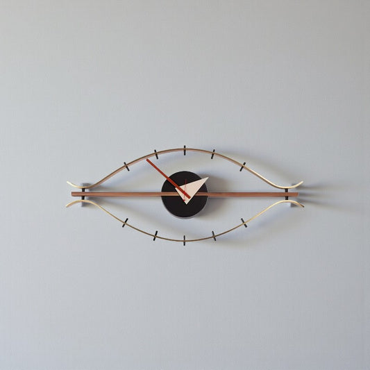 30-inch decorative wall clock - Ashen features an eye-shaped metal frame with a black clock face. Red and white hands add contrast, perfect for a vintage industrial touch from The Horologista.