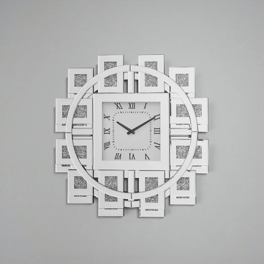 Decorative mirror wall clock - Stratton, featuring a square face with Roman numerals, slim hands, and a circular mirrored frame with geometric panels, adding a modern, glamorous touch to interiors.
