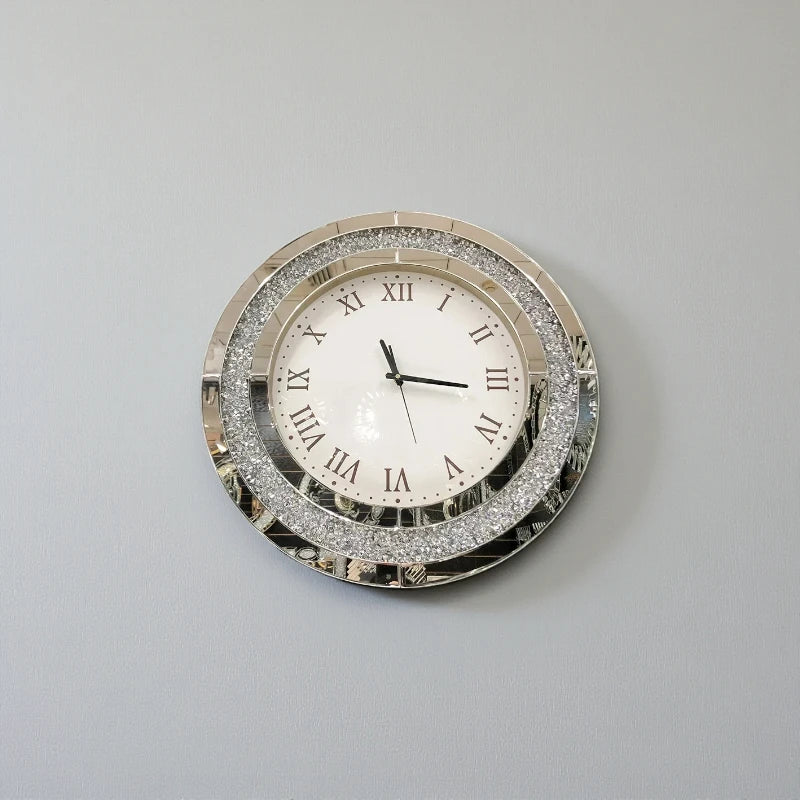 Fancy wall clock - Norwyn: A decorative round clock with a mirrored frame and glittering detail, featuring Roman numerals and sleek black hands, designed to be a room's elegant focal point.