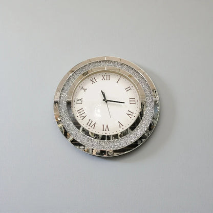 Fancy wall clock - Norwyn: A decorative round clock with a mirrored frame and glittering detail, featuring Roman numerals and sleek black hands, designed to be a room's elegant focal point.