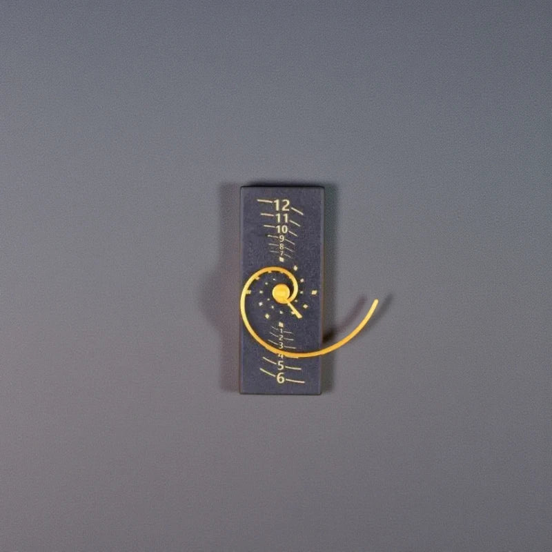 Fibonacci Wall Clock - Morston: A matte-black block with a white scale and a bright yellow spiral ribbon, inspired by the golden ratio, creating a minimalist art and mathematics statement piece.