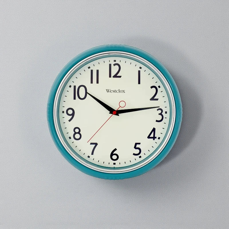 Blue metal Wall Clock - Farlton features a round teal frame with a classic analog face, displaying a time of 10:15. This modern clock adds a sleek, silent touch to any space.