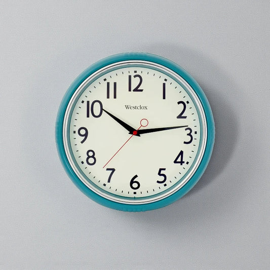 Blue metal Wall Clock - Farlton features a round teal frame with a classic analog face, displaying a time of 10:15. This modern clock adds a sleek, silent touch to any space.