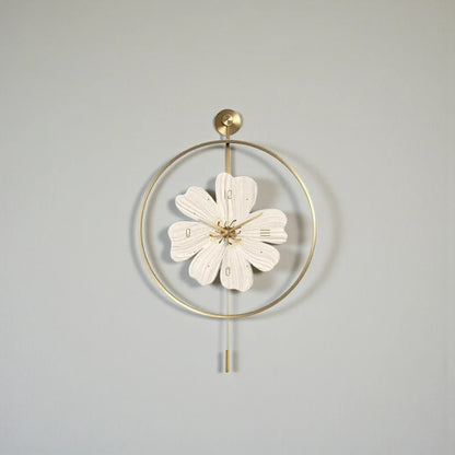 Flower wall clock - Fenton: A decorative piece with a gold-toned hoop and flower-shaped clock face, featuring gold hour-markings and minimalist pendulum rods, adding springtime charm to any wall.