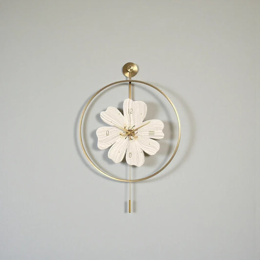 Flower wall clock - Fenton: A decorative piece with a gold-toned hoop and flower-shaped clock face, featuring gold hour-markings and minimalist pendulum rods, adding springtime charm to any wall.