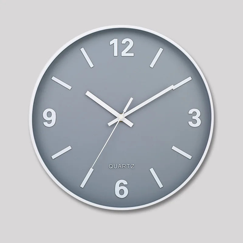 Modern Silent Wall Clock - Densford: A minimalist analog clock with a gray face, white frame, bold numerals at 12, 3, 6, 9, and silent non-ticking quartz movement, enhancing any room's elegance.