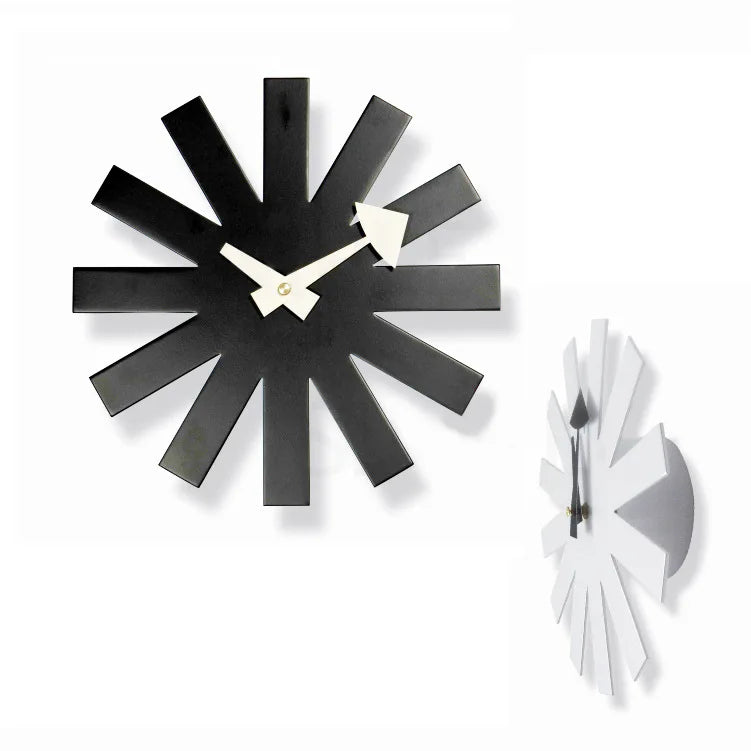 Back view of black metal clock showing battery compartment and wall hook