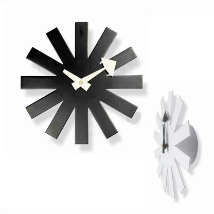 Back view of black metal clock showing battery compartment and wall hook