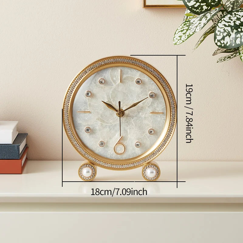 Silent Table Clock - Feynor: A gold-tone, round tabletop clock with a marble-like face, rhinestone markers, and faux pearl accents, perfect for elevating decor in various spaces.