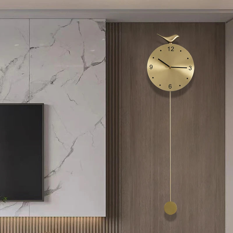 Modern pendulum wall clock - Majesty: A minimalist gold clock with a slim pendulum and ornamental bird, set into a wood-tone panel, enhancing contemporary decor with its sleek design.
