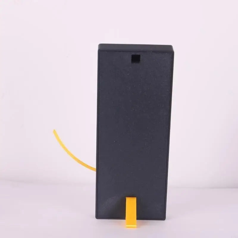 Fibonacci Wall Clock - Morston: A minimalist black rectangular housing with a visible yellow cable organized by a spool, symbolizing the blend of art and mathematics through the golden ratio spiral design.