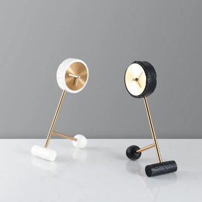 Metal Tabletop Clock - Winsley features an open-face design with decorative gears, gold-tone dial, and hands, set on angled gold rods. Includes white and black versions with minimalist cylindrical feet.