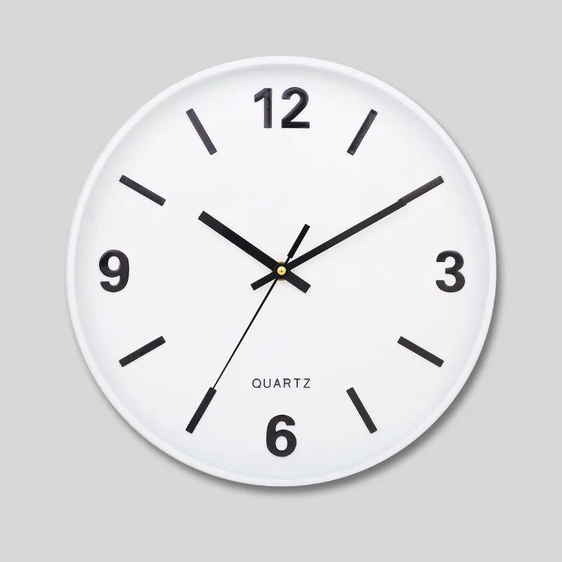 Modern Silent Wall Clock - Densford: A minimalist round white quartz wall clock featuring black hands and hour markers, with numerals at 12, 3, 6, and 9, offering silent, non-ticking elegance.