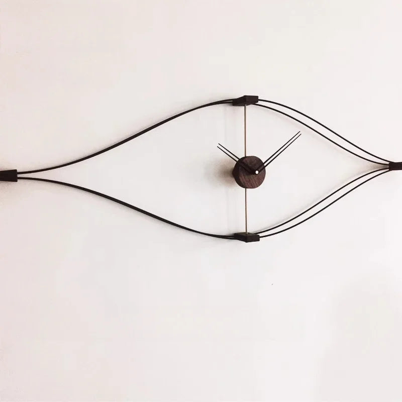 Modern geometric diamond wall clock with black metal wire frame and gold center hub