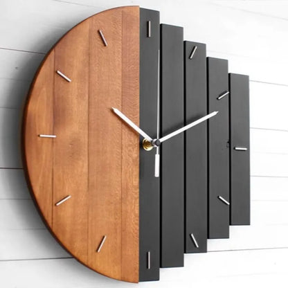 Modern wood wall clock - Clevor made from vertical wooden slats, half natural, half matte black, with metal tick-mark hour indices and minimal silver hands, mounted on a light-colored wall.