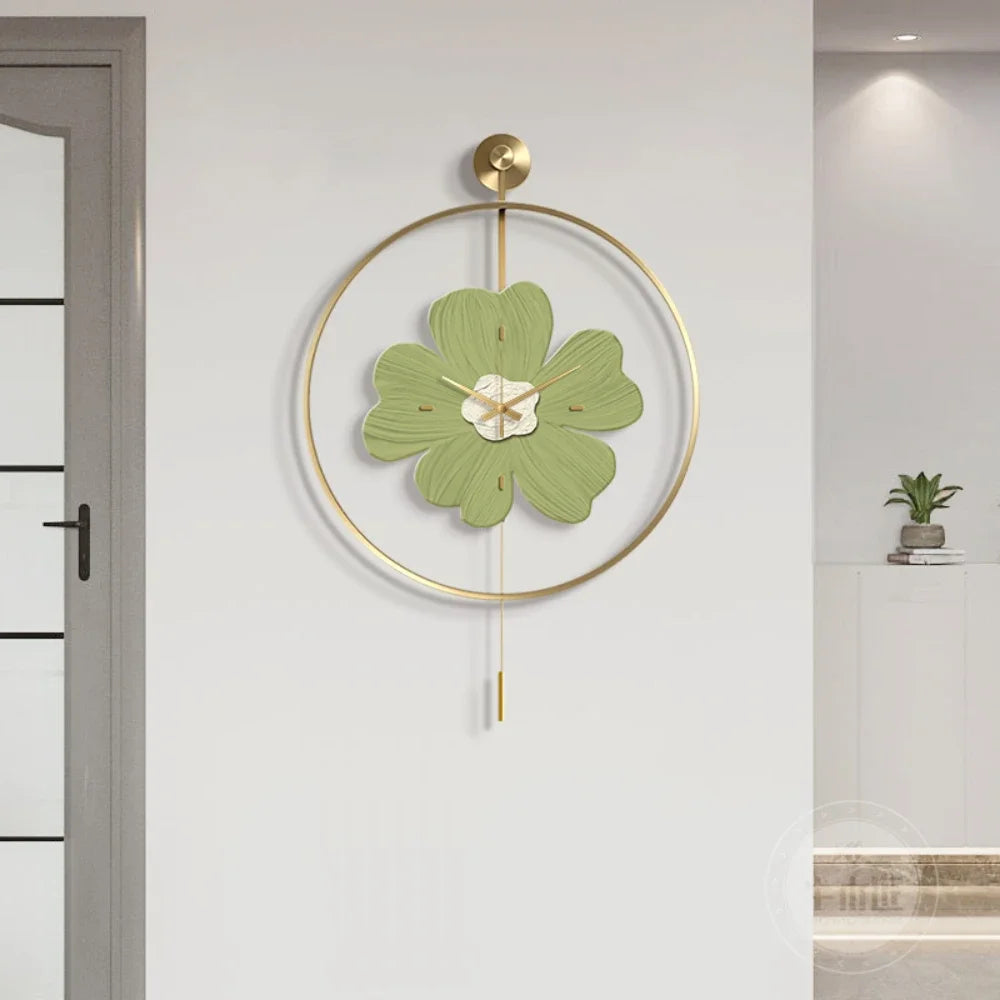 Flower wall clock - Fenton: A modern decorative clock features a gold-metal hoop with a pale green floral-shaped face and gold tick marks, complemented by a pendulum rod, perfect for contemporary interiors.