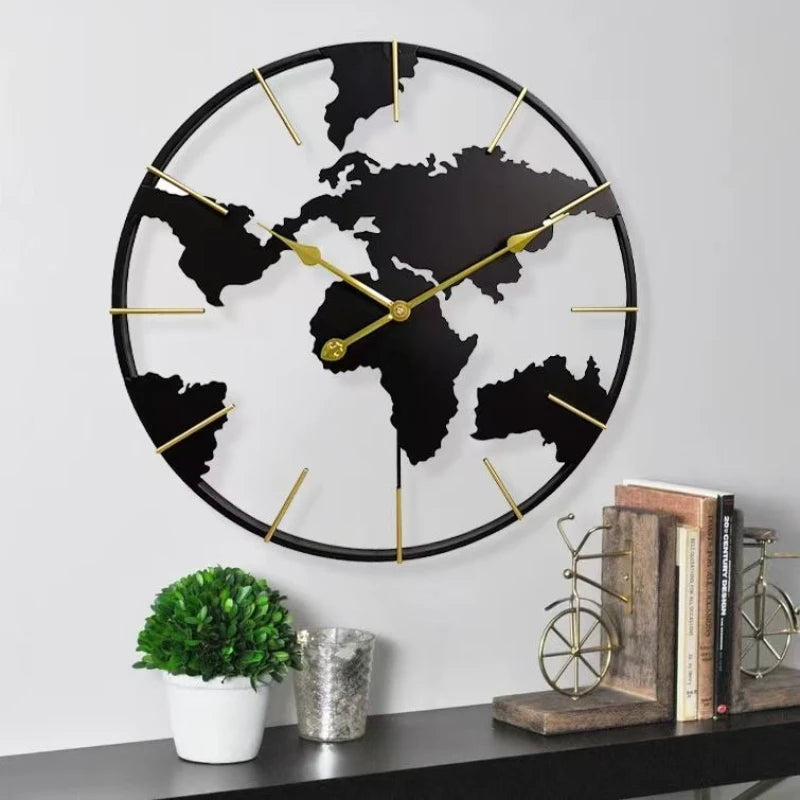 World Map Wall Clock - Claverton features continents cut out on a circular frame with brass-colored markers and hands, complementing a stylish shelf display of books and decor.