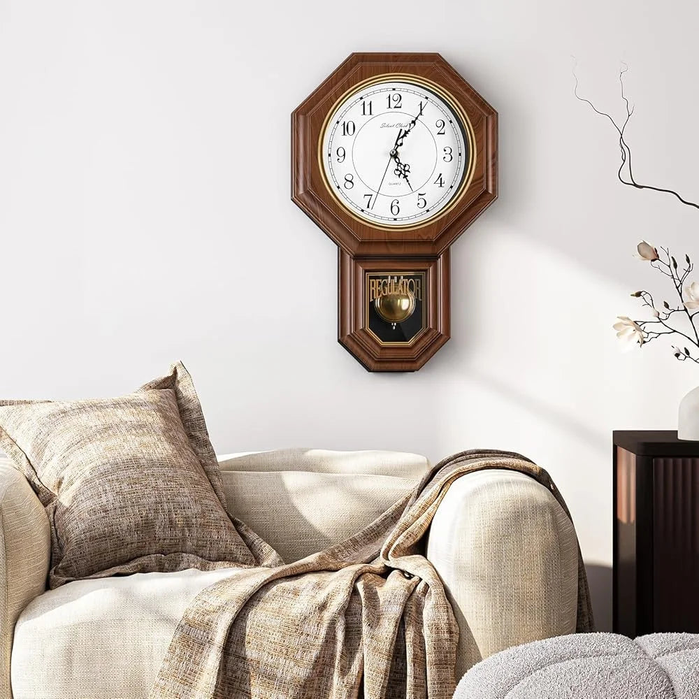 Vintage wall clock pendulum - Heritage: A regulator-style wall clock with a wooden finish and swinging pendulum, mounted on a white wall, adding timeless elegance to a cozy sitting area.