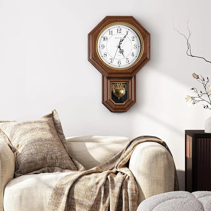 Vintage wall clock pendulum - Heritage: A regulator-style wall clock with a wooden finish and swinging pendulum, mounted on a white wall, adding timeless elegance to a cozy sitting area.