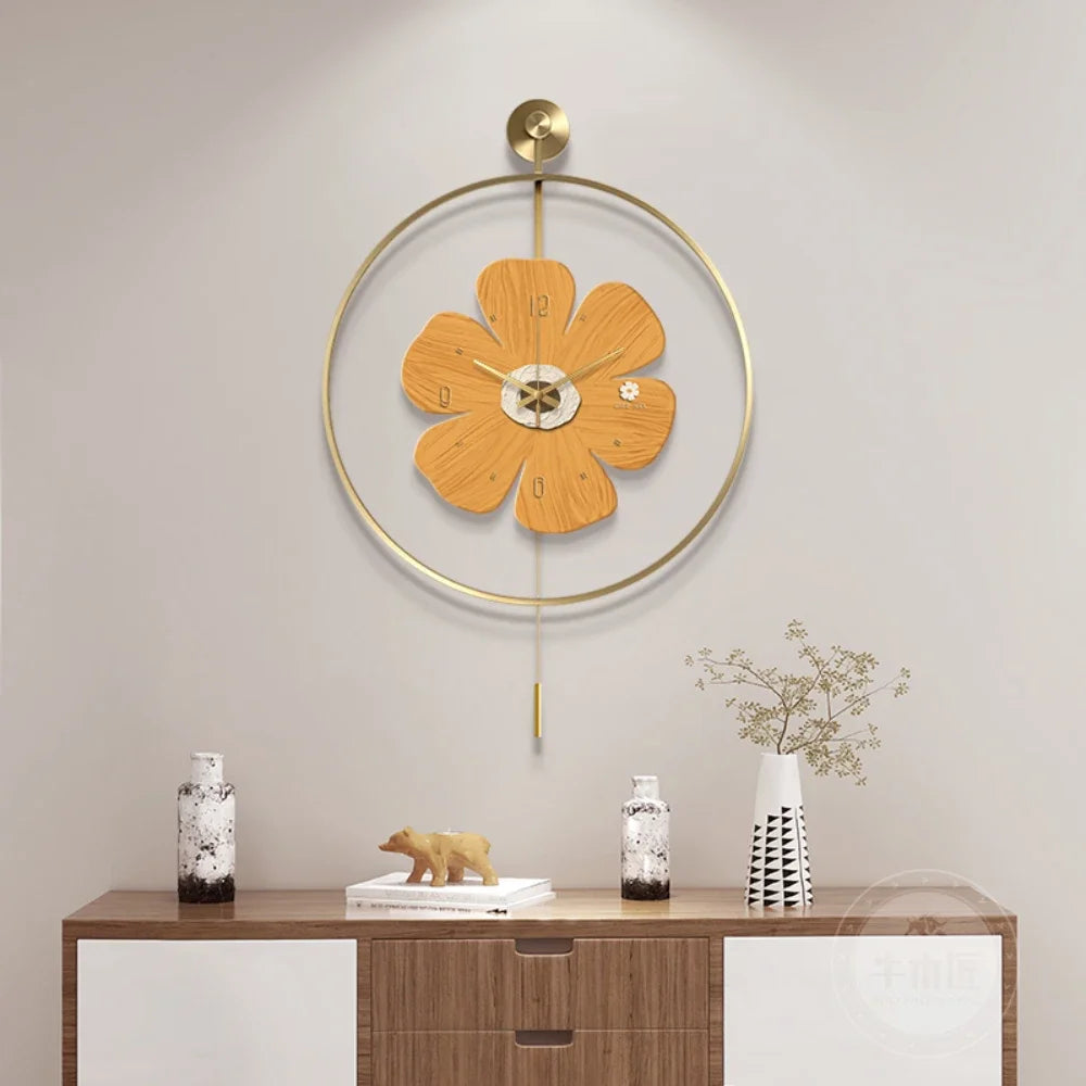 Flower wall clock - Fenton: A modern clock with light wood petals, housed in a gold-finished ring with a pendulum. It hangs above a stylish sideboard, adding charm to any space.