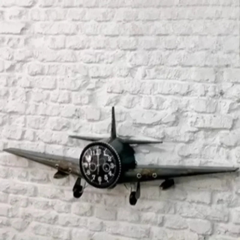 Metal airplane wall clock showing brushed iron finish and landing gear details