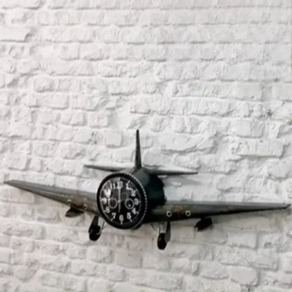 Metal airplane wall clock showing brushed iron finish and landing gear details