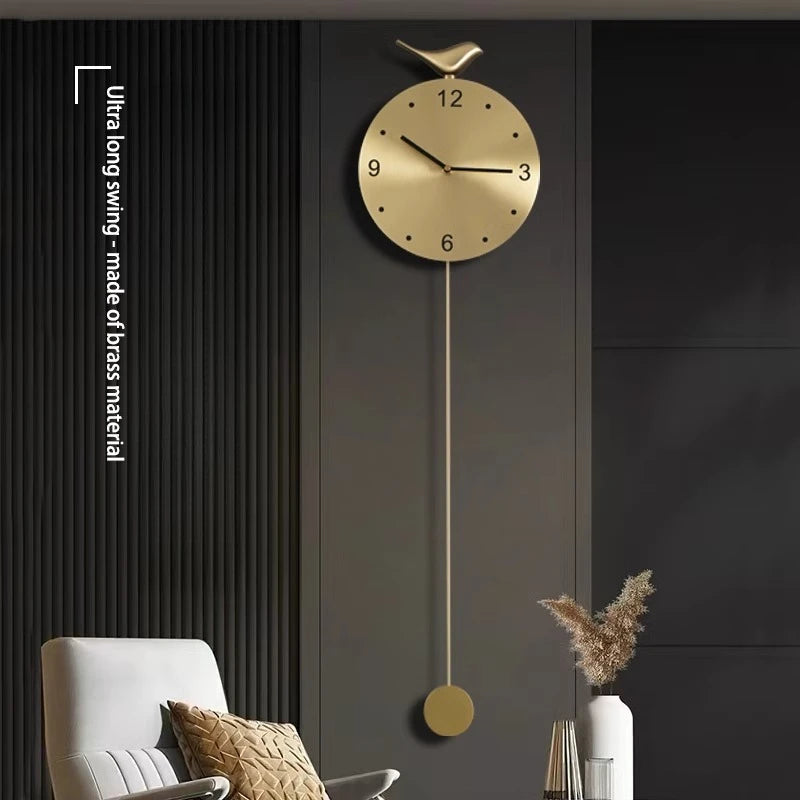 Modern pendulum wall clock - Majesty features a sleek brass design with a minimalist gold face and slender black hands, complemented by a decorative bird. Perfect for enhancing contemporary decor.