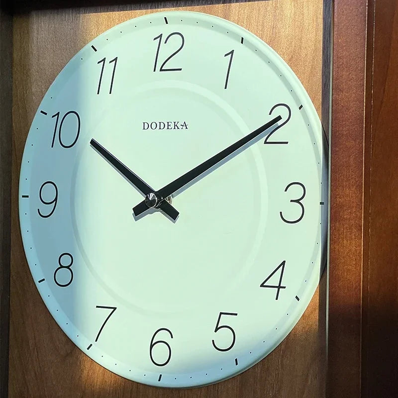 Japanese Wall Clock - Lexton by DODEKA: This minimalist wall clock features a mint-green face with black markers and hands, embodying tranquility and elegance against a wooden backdrop, perfect for serene home decor.