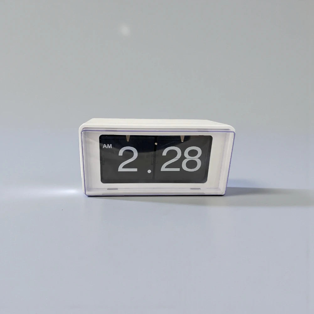 Vintage flip clock - TimeFlip A small, rectangular flip-style clock with a white housing and black display cards, showcasing large white numerals. It reads “AM 2:28,” embodying retro charm and functionality.