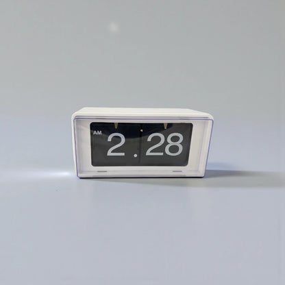 Vintage flip clock - TimeFlip A small, rectangular flip-style clock with a white housing and black display cards, showcasing large white numerals. It reads “AM 2:28,” embodying retro charm and functionality.