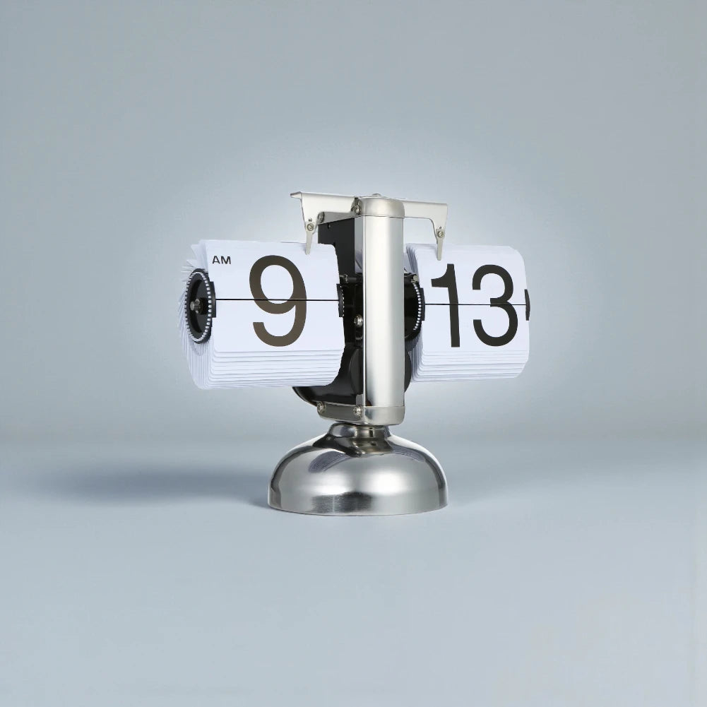 Retro flip clock - Jorrel: A metallic flip clock featuring dual drum mechanisms with numbered cards, displaying AM 9:13, perfect for adding a vintage touch to any desk or shelf.