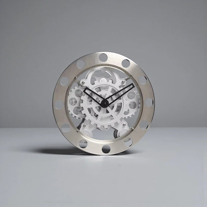 Modern Wall Clock Design - Elverton: This clock features a brushed-metal outer ring with cut-outs, showcasing exposed white gears and slim black hands, embodying a sleek mechanical aesthetic.