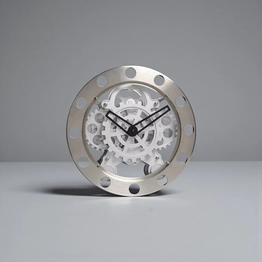 Modern Wall Clock Design - Elverton: This clock features a brushed-metal outer ring with cut-outs, showcasing exposed white gears and slim black hands, embodying a sleek mechanical aesthetic.