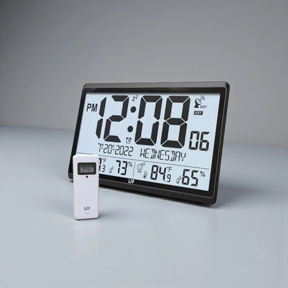 Atomic wall clock - Harven: Tabletop digital clock/weather-station with large LCD displaying time, date, indoor/outdoor temperature, humidity, and wireless sensor module for precise, atomic-synced timekeeping.