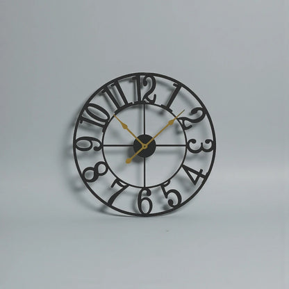 Oversized Wall Clock - Alderton features a distressed black metal frame, cut-out numerals, and gold hands on a light background. Visible 3D moving gears add dynamic visual interest.