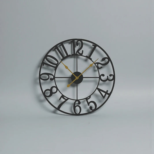 Oversized Wall Clock - Alderton features a distressed black metal frame, cut-out numerals, and gold hands on a light background. Visible 3D moving gears add dynamic visual interest.