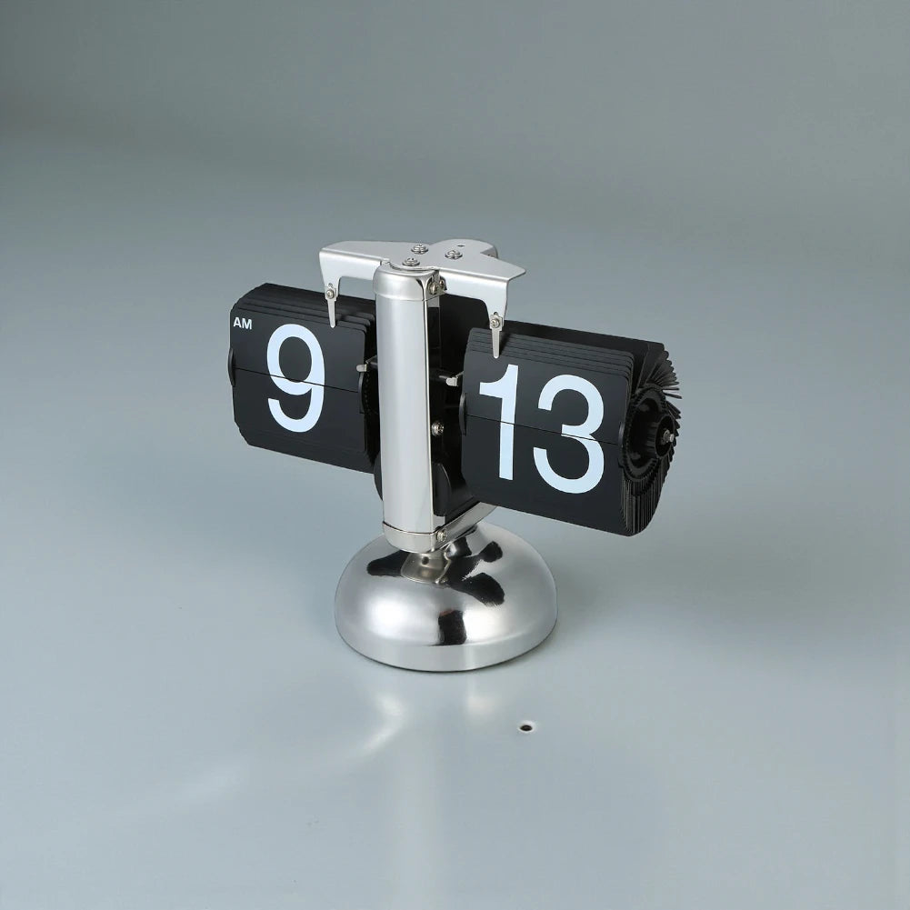 Retro flip clock - Jorrel: A desk flip clock with black numeral cards showing 9:13 AM, mounted on a polished metal pedestal, adding vintage charm to your space.