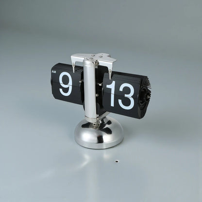 Retro flip clock - Jorrel: A desk flip clock with black numeral cards showing 9:13 AM, mounted on a polished metal pedestal, adding vintage charm to your space.