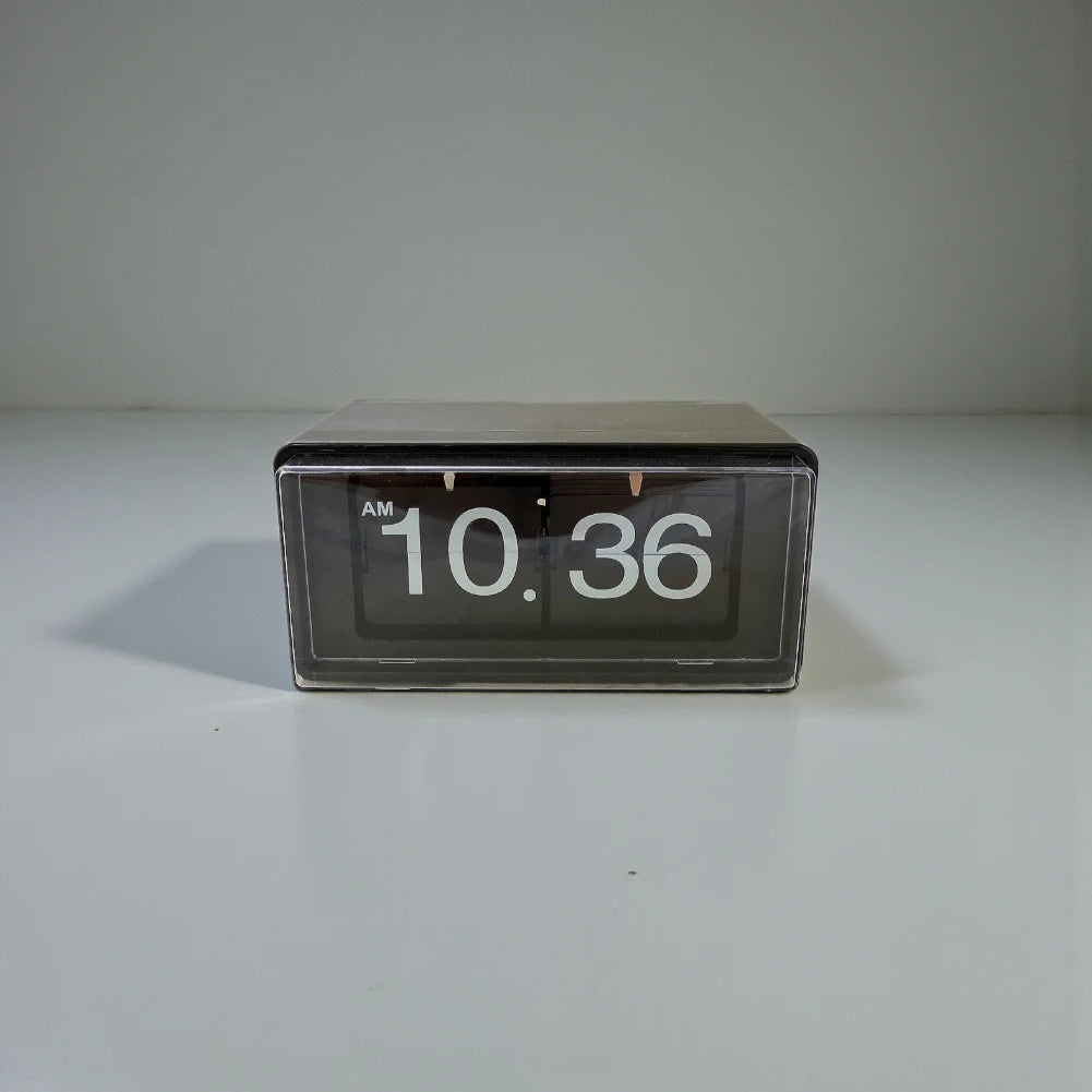 Vintage flip clock - TimeFlip with a black rectangular body and clear front, displaying white numerals 10:36 AM. A retro timepiece, perfect for adding a classic touch to any space.