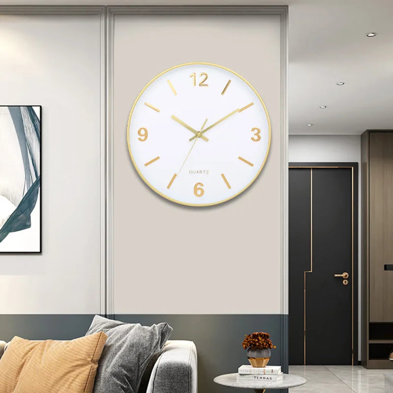Modern Silent Wall Clock - Densford with a white face and gold frame, prominently displayed on a stylish corner wall, enhancing the contemporary elegance of the minimalist room setting.